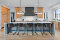 Oversized kitchen island with waterfall countertops