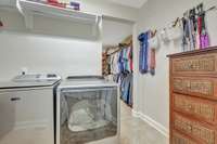 Private laundry room opens to the enormous custom closet~This was a custom revision to the original floorplan~Additional washer/dryer connections are located in the pantry adjacent to the garage entry.