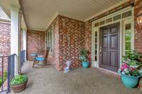 Covered front porch offers several sitting areas~Room to add a porch swing~Electricic outlet by the front door is ideal for seasonal lighting accents.