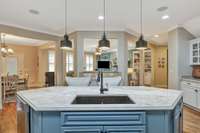 View from kitchen~Oversized island with copper sink~Very open flow between the living area, breakfast area, dining room and kitchen~Raised height separate bar area provides privacy from kitchen activity.