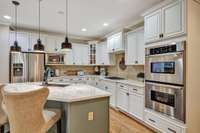 Kitchen updates/upgrades include painted cabinets, Quartzite countertops, copper sink, pendant lights and surround sound~There is also a planning/homework desk immediately behind this picture.