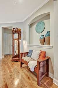 Sitting area with art niche in the entry foyer~Coat closet is directly across from the art niche.