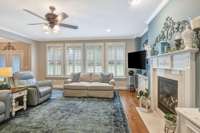 Main level living area~ Wall of windows overlooking the private backyard~Recessed lighing~Floating floor outlets allow for flexible furnitrue placement.