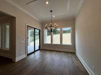 Dining room surrounded by natural light and view of the spacious backyard.