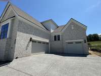 Two car side entry garage with a one car carriage garage.