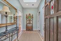 Entrance of home with tile flooring and skylight letting in natural light.