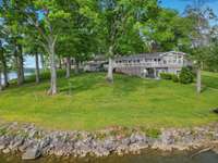 So much yard and green space overlooking the water.