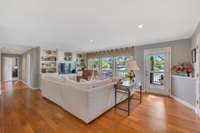 Living area with built in shelving and views of the lake everywhere you look.