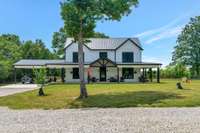 Custom built in 2021, this home offers a full wrap around porch