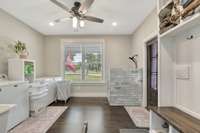 Just off the kitchen is very spacious mudd/laundry room, featuring, a was tub, doggie shower and storage area