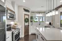 Another view of the kitchen, featuring quartz counter tops and your view from the sink