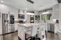 The kitchen is a delight to cook in, with oversized island & crank out windows over the sink, you can fully enjoy the outdoors while inside