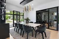 Dining room with built-in cabinetry and a 350-bottle wine cellar with commercial grade cooling/humidification system and tempered glass walls.