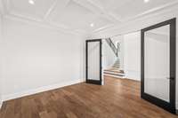 Black accent doors add privacy to the Study when needed. Notice the coffered ceiling with trim work.