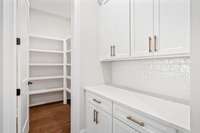 Large walk in pantry is located off of the Kitchen.