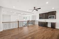 The upstairs Game room with hardwood floors and entertainment bar area