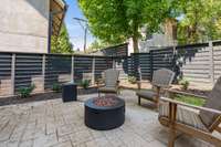 Step down to the patio to enjoy the fire pit inside your private, beautifully landscaped, fenced yard