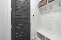 Entry from garage with convenient hooks and cubbies for storage