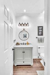 Main floor powder room with new vanity, mirror and lighting