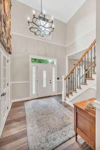 Two story entry with decorative chandelier.