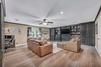 Oversized bonus room with ceiling fan, built in cabinetry/shelving