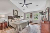 Master Bedroom with vaulted ceiling, ceiling fan with light and new windows with built-in blinds