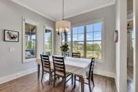 The breakfast table also has a view of the covered patio/porch and the beautiful backyard.