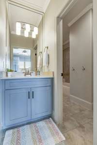 The tub and shower are separate from the vanity with a door to provide privacy.