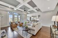 The great room is accented by two large, French doors beside two floor-to-transom windows that lead to the covered porch.