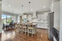 A breakfast nook, next to the kitchen, is lit by large triple windows and offers additional seating for six.