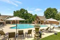 Umbrellas, tables, chairs and lounge chairs are provided for residents use.