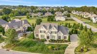 The three-car, side entry garage at this home has a large parking pad for ease of use.