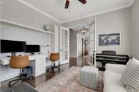 Plenty of shelves are hidden behind the doors of floor to ceiling cabinets in this study space.