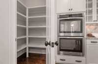 Double ovens and huge full wood shelved pantry.