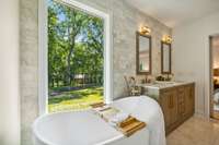 The primary bathroom was re-configured to allow for a new soaking tub, double vanity, huge walk-in shower, and marble walls and flooring.