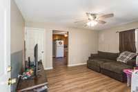 Inside, you'll find a cozy living room with laminate flooring and ceiling fan.