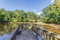 One of the four ponds on this stunning farm features a pier that stretches out into the serene waters.