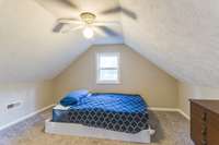 Third bedroom with carpet, ceiling fan and closet.