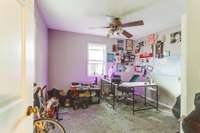 The downstairs bedroom has carpet, ceiling fan and a closet.