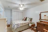 This apartment features a comfortable bedroom with carpet, closet, ceiling fan and side entry door.