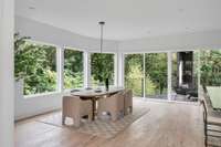 The dining area almost feels like it's in the trees thanks to the adjacent park and the large picture windows that carry over.