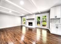 View of den with gas fireplace. French doors lead out to nice aggregate patio.