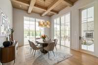 Breakfast Room with beautiful floor-to-ceiling windows, stained coffered with shiplap ceiling, and access to covered outdoor living area