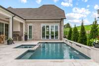 Game Room on the main level with wet bar and sliding doors with access to Pool and outdoor luxury living space