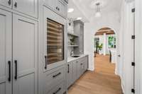 Elegant butler pantry joins the formal dining with the grand kitchen.