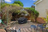 Brick enclosed private courtyard with brick pavers and arbor