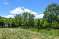 Flat and fenced backyard that backs to trees- a DREAM! This space offers room to add a pool. Ask to see the sellers pool plans!