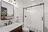 Renovated en-suite bathroom with custom tile.