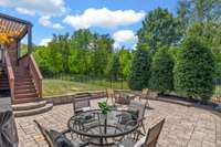 Nearly 550 sq. feet of Paver patio with built-in fire pit and seating area. Lush, mature landscaping surrounds this space and is seen throughout the backyard.