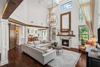 2 story living area with restoration hardware chandelier is the perfect spot to entertain guests or relax with family.